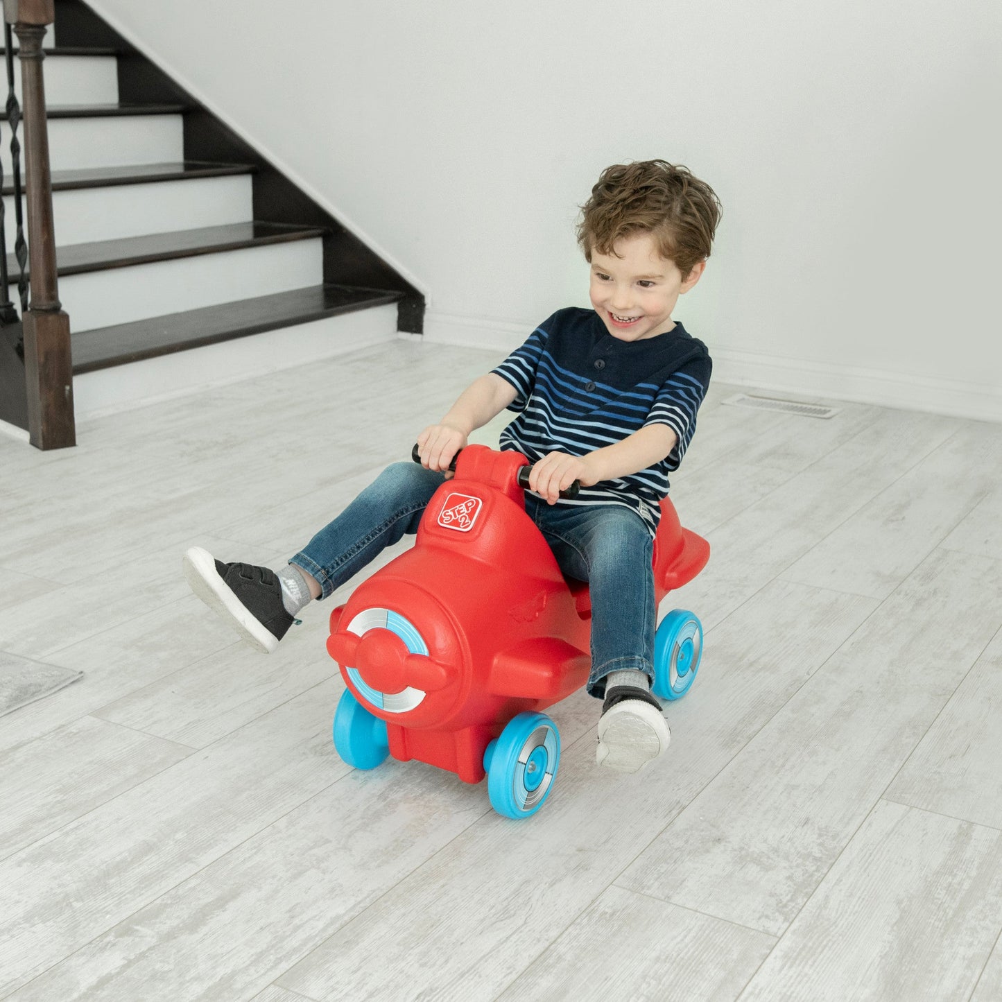 Sky Rider Foot-to-Floor Ride-On with child riding indoors