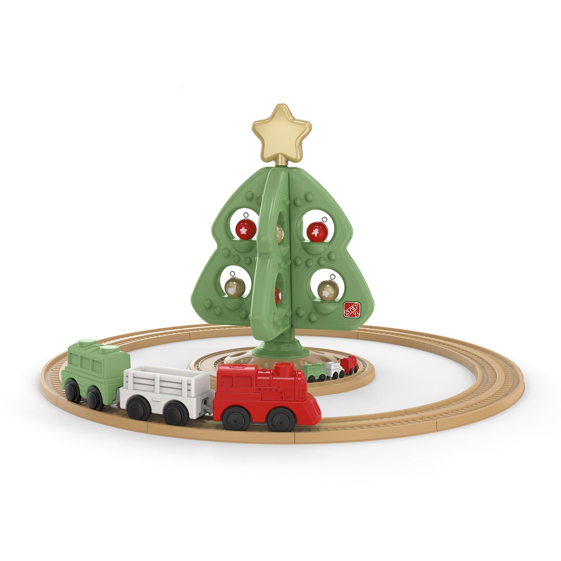 Toy Christmas tree with train tracks and a toy train on a white background
