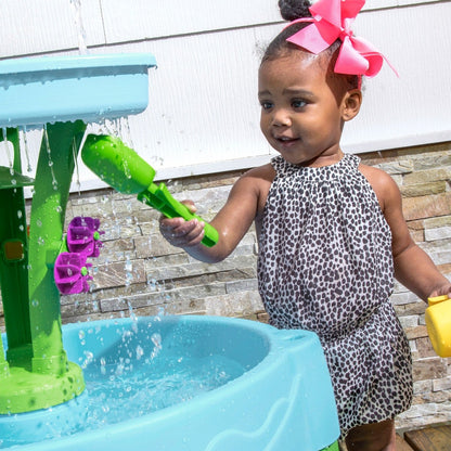 Spring Time Splash Water Table child scooping water