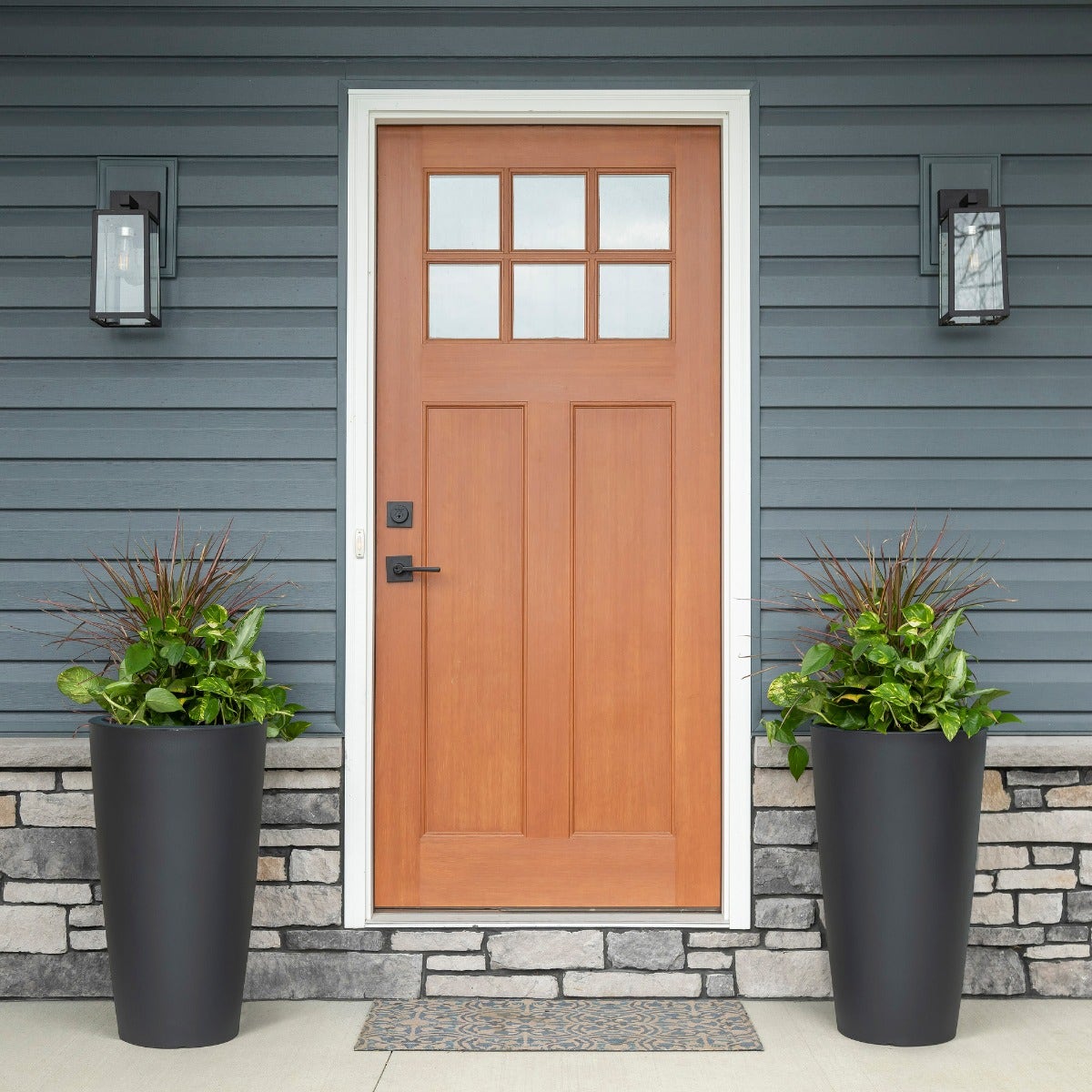 Tremont Tall Round Tapered Planter front porch with 2 planters.
