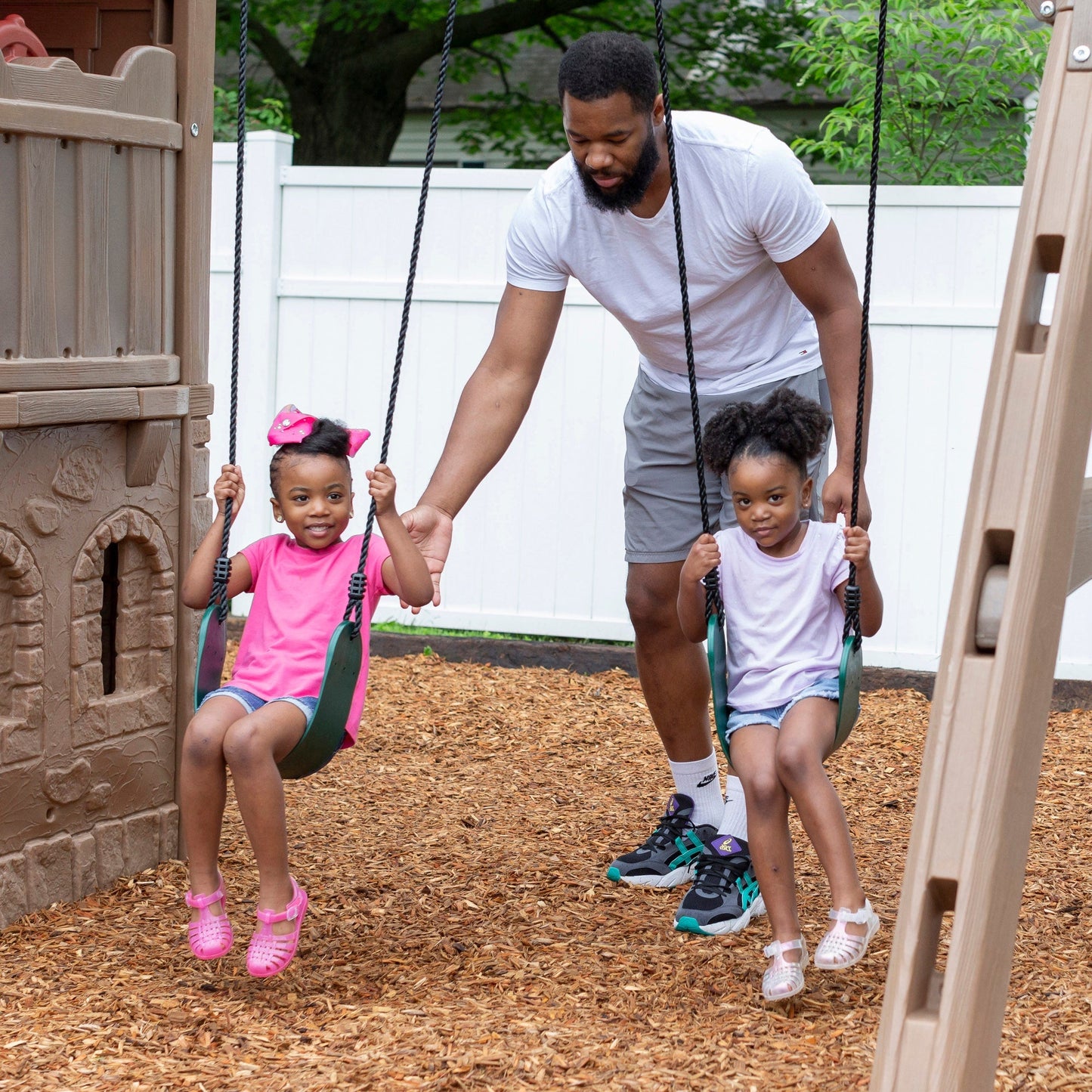 Naturally Playful™ Adventure Lodge Play Center  girls swinging