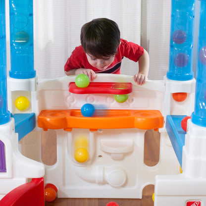 WonderBall Fun House™ child dropping ball through holes