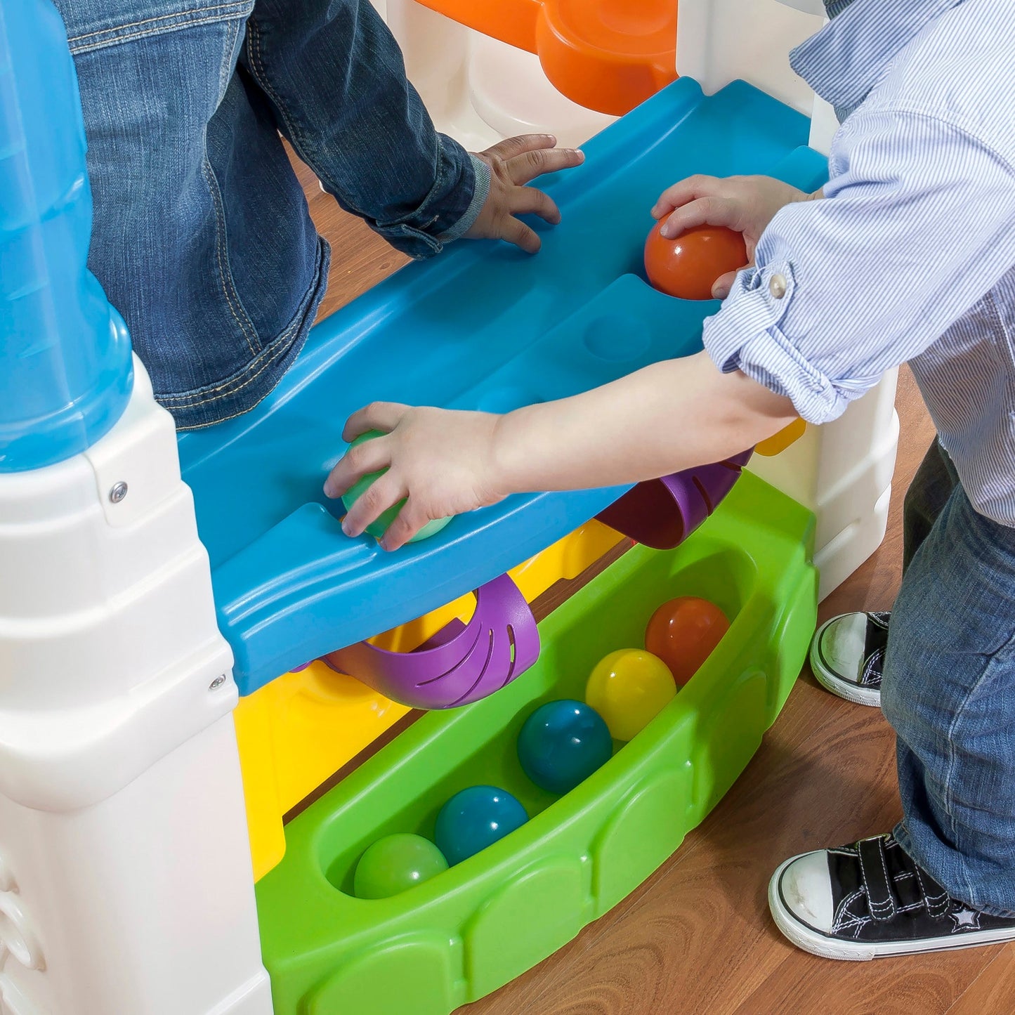 WonderBall Fun House™ child putting balls down holes