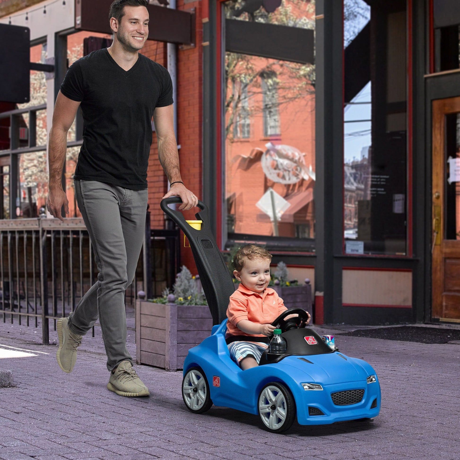 Whisper Ride Cruiser - Blue with man pushing