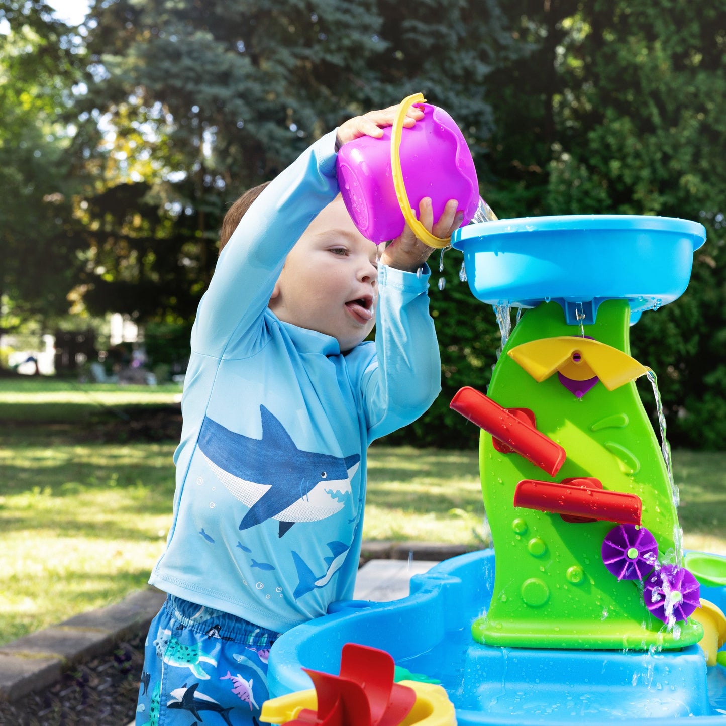 Rain Showers Splash Pond Water Table™ with Cover child pouring water